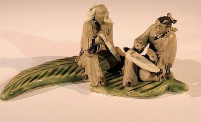 Miniature Ceramic Figurine <br>Two Mud Men On A Leaf, One Sitting Holding a Fan, The Other Sitting With Musical Instrument- 2