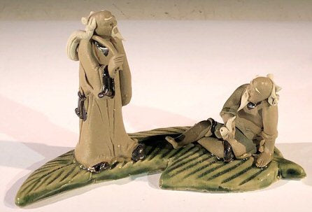 Miniature Ceramic Figurine <br>Two Mud Men On A Leaf, One Standing holding a bag, The Other Sitting Smoking a Pipe- 3