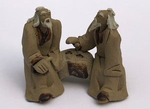 Ceramic Figurine<br>Two Mud Men Sitting On A Bench Playing Chess<br>2"
