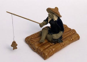 Miniature Ceramic Figurine<br>Glazed Fisherman Sitting On Raft<br>2.75"