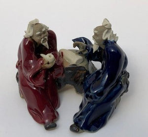 Ceramic Figurine<br>Two Men Sitting On A Bench Holding a Pipe- 2.25"<br>Color: Blue & Red